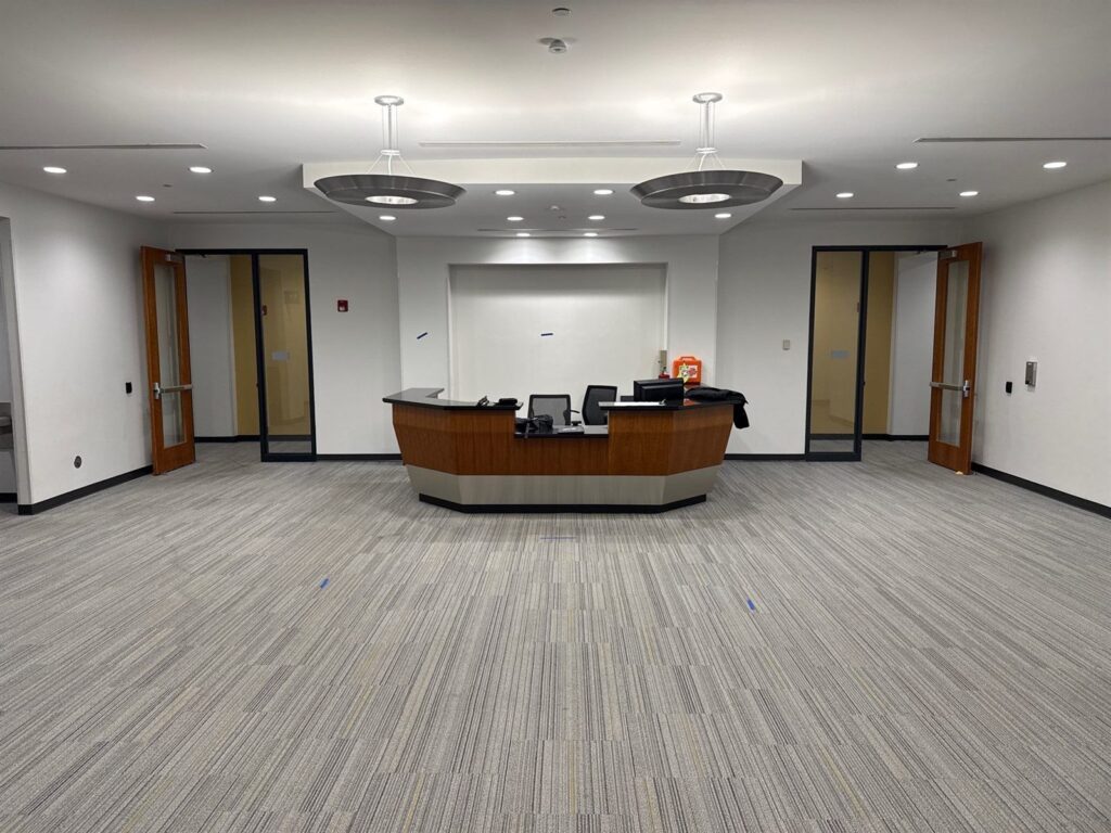 Finished commercial reception area with new carpet and lighting after reconstruction